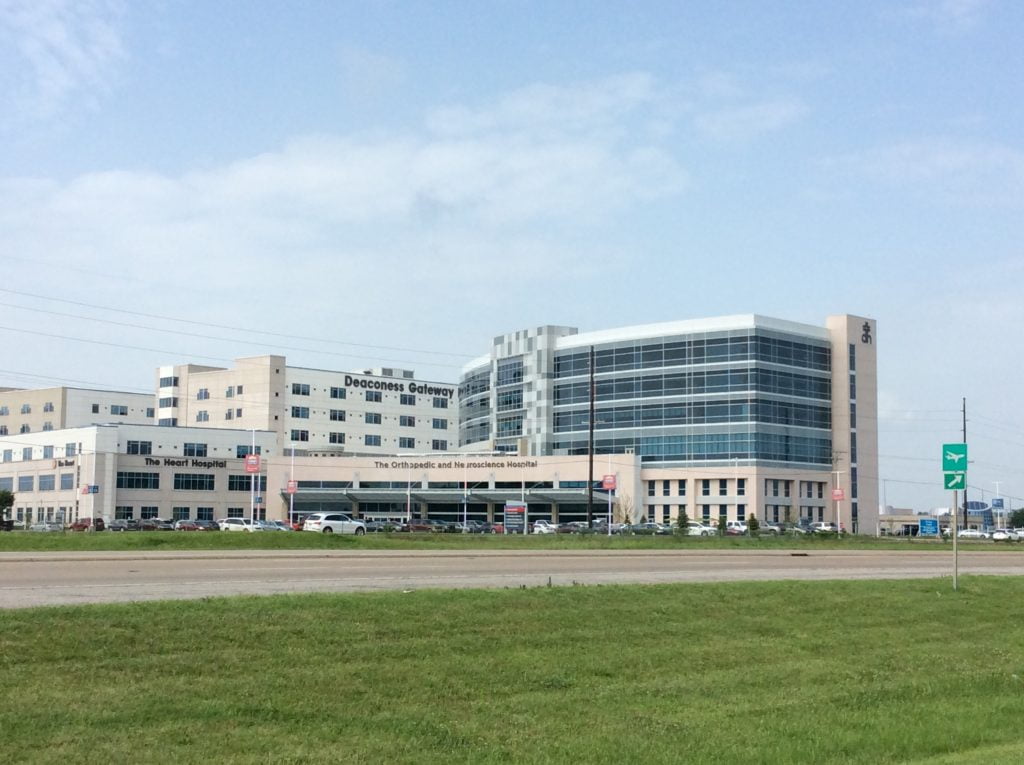 landscape view of large hospital building with glass curtainwall